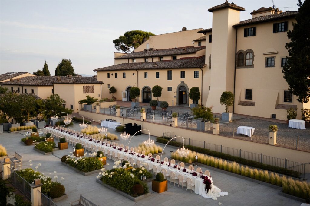 An Unforgettable Anniversary at Castello del Nero: A Three-Day Celebration in Tuscany 37 Elegant long table setting for an outdoor event at a Tuscan villa. Anniversary Castello del Nero - Italian Wedding Designer