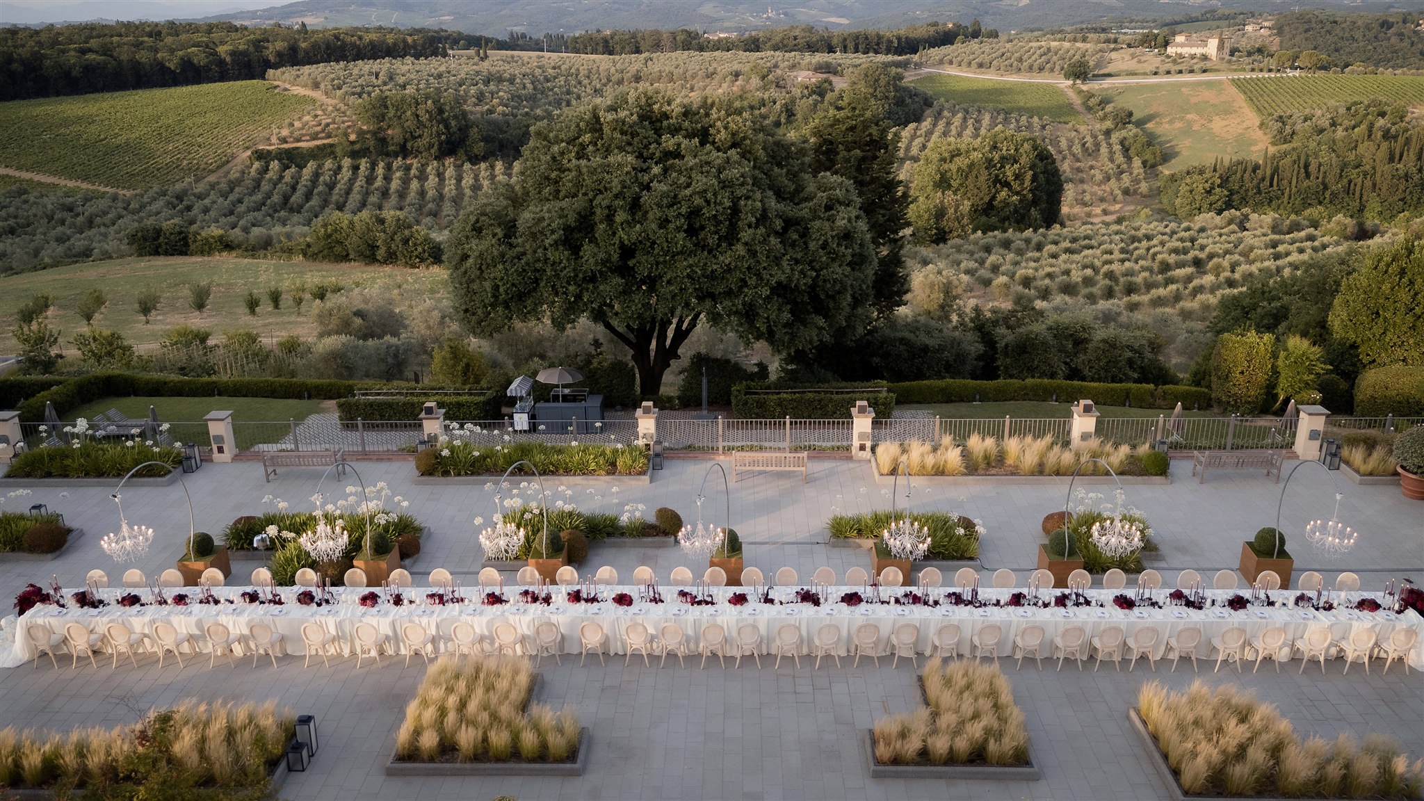 An Unforgettable Anniversary at Castello del Nero: A Three-Day Celebration in Tuscany 1 Elegant long table setting for an outdoor event in a Tuscan vineyard-. Anniversary at Castello del Nero - Italian Wedding Designer