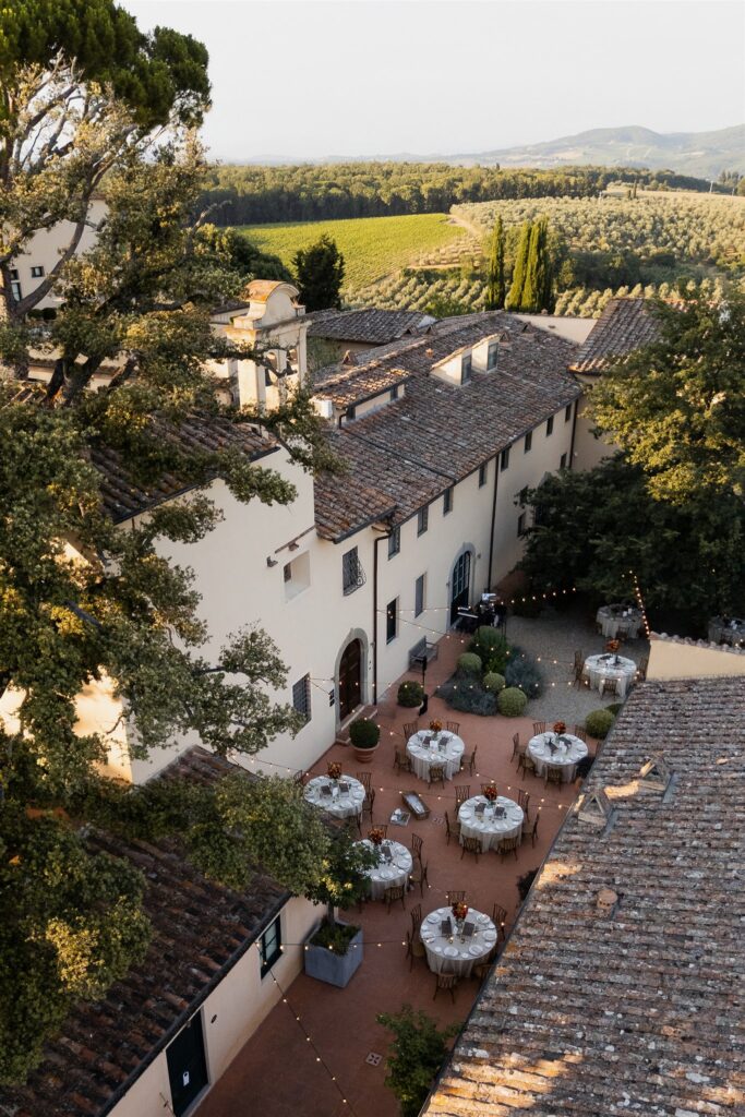 An Unforgettable Anniversary at Castello del Nero: A Three-Day Celebration in Tuscany 9 Tuscan villa courtyard set up for an outdoor wedding reception with string lights. Anniversary Castello del Nero - Italian Wedding Designer