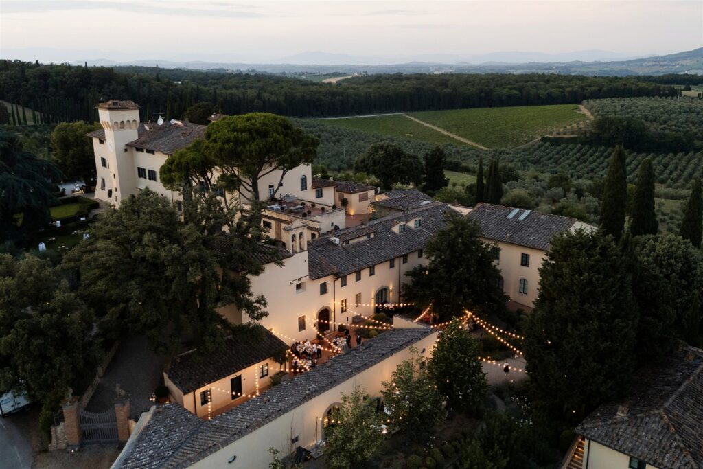 An Unforgettable Anniversary at Castello del Nero: A Three-Day Celebration in Tuscany 20 Tuscan villa at dusk with outdoor dining and string lights. Anniversary Castello del Nero - Italian Wedding Designer