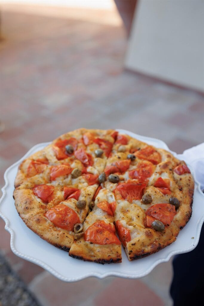 An Unforgettable Anniversary at Castello del Nero: A Three-Day Celebration in Tuscany 6 Fresh focaccia pizza topped with tomatoes and olives. Anniversary Castello del Nero - Italian Wedding Designer